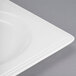 A close-up of a white square Libbey Slenda Valla porcelain plate with a square edge.