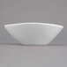A Libbey white porcelain bowl with a small rim on a gray surface.