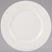 A white Tuxton china plate with a ribbed rim.