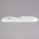 A white oval porcelain serving tray with two wells.