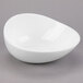 A white Libbey Slenda Verve bowl with a curved edge on a gray surface.