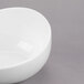 A close up of a white Libbey Royal Rideau porcelain bowl with a small hole in the middle.