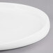 A close-up of a white Libbey porcelain platter with a curved edge.