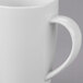 A close up of a white Libbey porcelain mug with a handle.