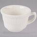 A white Tuxton Hampshire china cup with a handle.