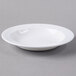 A Libbey Royal Rideau white porcelain deep rimmed soup bowl on a gray surface.