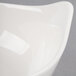 A close-up of a Libbey Royal Rideau white porcelain bowl with a curved edge.