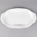 A white porcelain handle platter with curved edges.