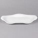 A white Libbey porcelain platter with a curved edge.