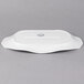 A white rectangular porcelain platter with a handle.