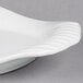 A close up of a white Libbey Royal Rideau porcelain platter with a wavy edge.