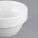 A Libbey Royal Rideau white round porcelain ramekin on a gray surface.
