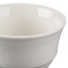A close up of a white unhandled porcelain bouillon bowl.