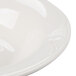 A white porcelain fruit bowl with a white rim.
