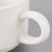 A close-up of a white Reserve by Libbey Royal Rideau porcelain mug with a handle.