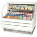 A white Turbo Air Low Profile Horizontal Air Curtain Display Case with food displayed inside.