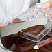Melted chocolate being poured into a Matfer Bourgeat plastic tray.