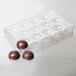 A Chocolate World plastic mold with round chocolate balls.