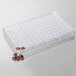 A clear plastic Matfer Bourgeat chocolate mold tray with round compartments containing brown round coffee bean candies.