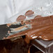 A knife cutting chocolate into a Matfer Bourgeat plastic chocolate mold shaped like hearts.