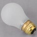 A Satco frosted rough service light bulb with a gold base on a gray surface.
