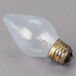 A Satco clear 60 watt incandescent light bulb with a brass base.