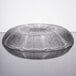 An Arcoroc glass bowl with a pattern on a table.