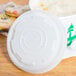 A white EcoChoice PLA plastic lid on a white paper cup of food.