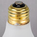 A Satco frosted incandescent rough service light bulb with a gold cap.