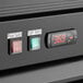 The digital display and switch on a black Avantco GDC-69-HC swing glass door refrigerator.