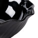 A close-up of a black Cambro swirl bowl with a wavy edge.