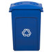 A blue Rubbermaid recycling bin with white recycle symbols on the lid.