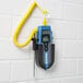 A Cooper-Atkins EconoTemp Type-K Thermocouple Thermometer with a yellow cord attached to a white brick wall.