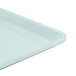 A close-up of a sky blue Cambro dietary tray with a white bottom.