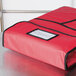 A red Intedge insulated delivery bag with black trim and a black zipper.