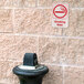 A red and white Thunder Group Smoking Area sign on a brick wall.