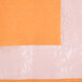 A close-up of a Creative Converting Pumpkin Spice Orange Tissue / Poly Table Cover package with a piece of paper inside.