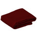 A folded burgundy Intedge cloth table cover.