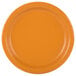 A close-up of an orange paper plate with a pumpkin spice orange background.