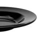 A close-up of a black GET Elegance bowl with a rim on a table.