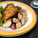 A Kanello Diamond Ivory melamine plate with chicken, potatoes, and asparagus on it.