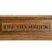 A dark oak Micro Matic Kool-Rite Irish Coffin Box with a shamrock carved in it.