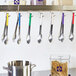 A kitchen with many utensils hanging from hooks.