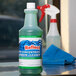 A close-up of a bottle of Noble Chemical Reflect Super Concentrated Window Cleaner.