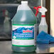 A close-up of a container of Noble Chemical Reflect Super Concentrated Window Cleaner.