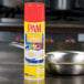 A pan with eggs next to a can of PAM Buttercoat Release Spray.