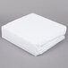 A white folded JT Eaton Twin Size Bed Bug Mattress Cover on a gray surface.