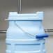 A Vollrath blue plastic bucket lid with a handle.