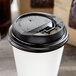 Choice Black Hot Paper Cup Travel Lid with Hinged Tab for 10-24 oz. Standard Cups and 8 oz. Squat Cups - 1000/Case Main Thumbnail 4