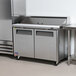 A Turbo Air stainless steel refrigerator with two doors on a counter.